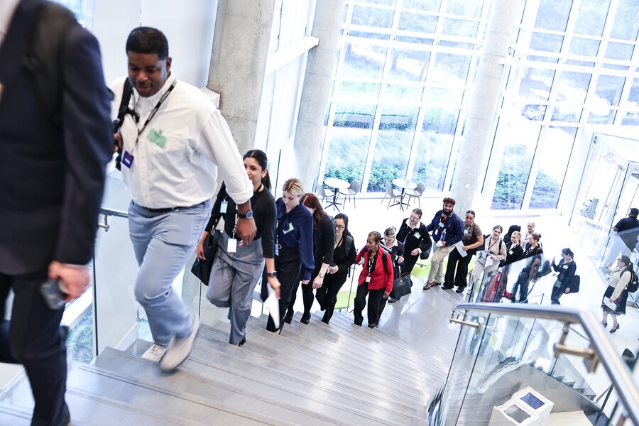A group heading upstairs into the campus lobby