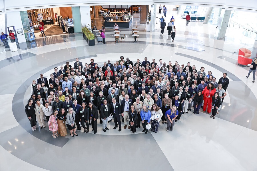 A full new hire class gathered in the campus atrium