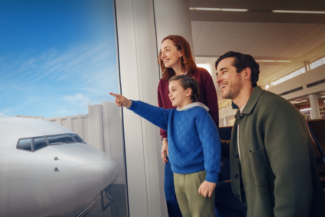 A family watching planes from the terminal